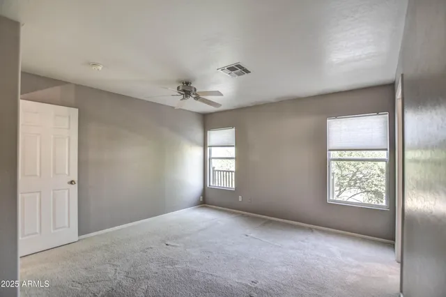 an empty room with windows and closet