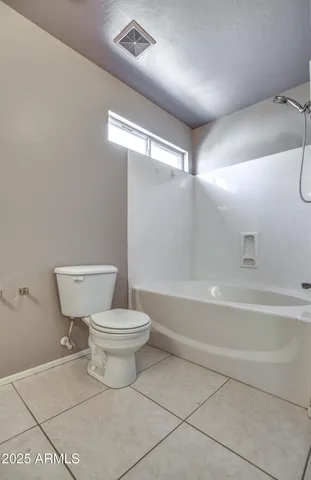 a bathroom with a toilet a sink and a shower