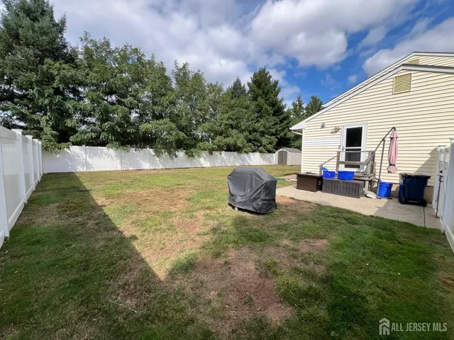a view of a white house with a yard