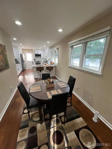 a view of a dining room with furniture and window