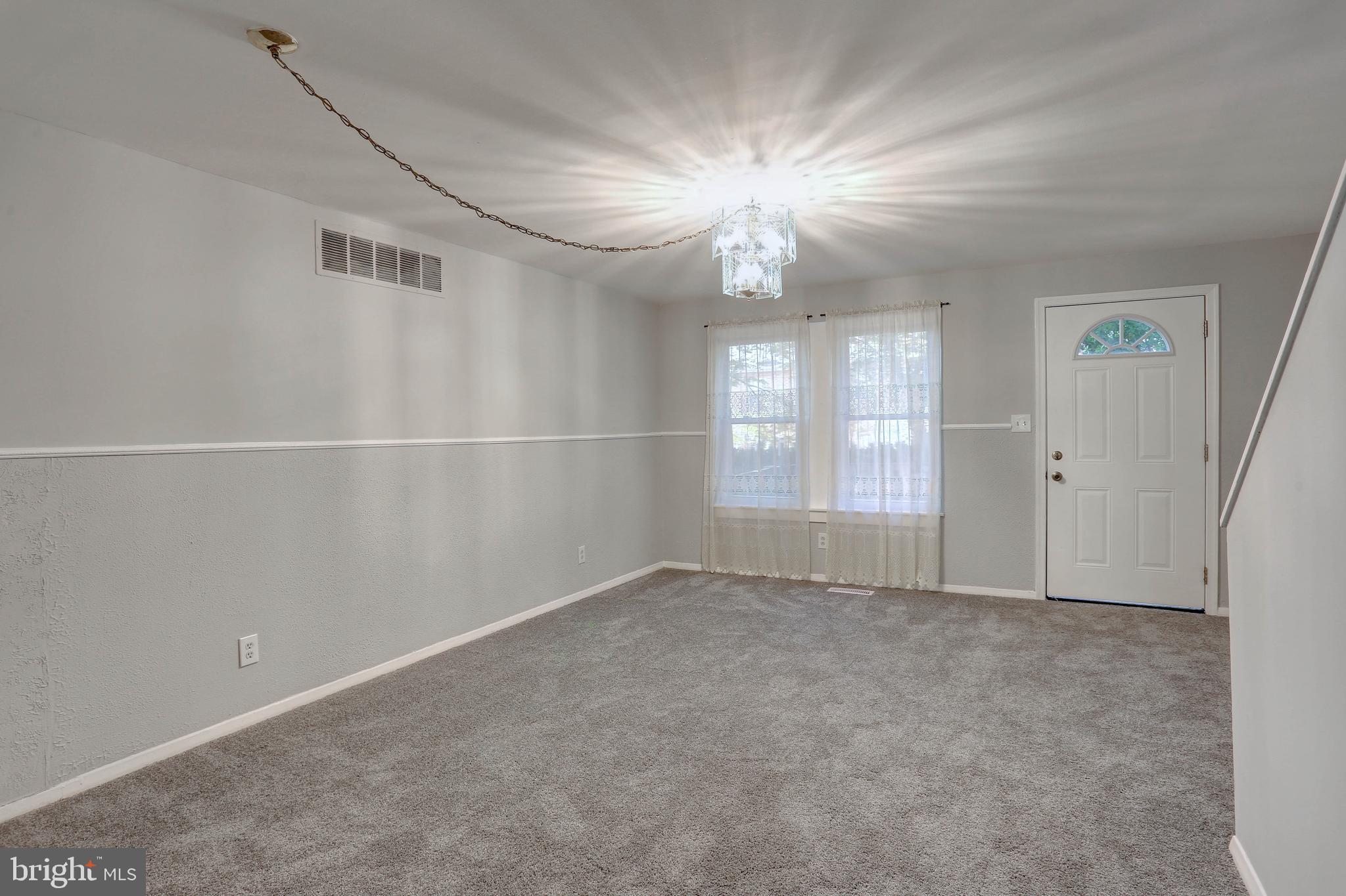 410 South Washington Street Baltimore, MD 21231 - Photo 19 of 29 an empty room with windows and chandelier fan