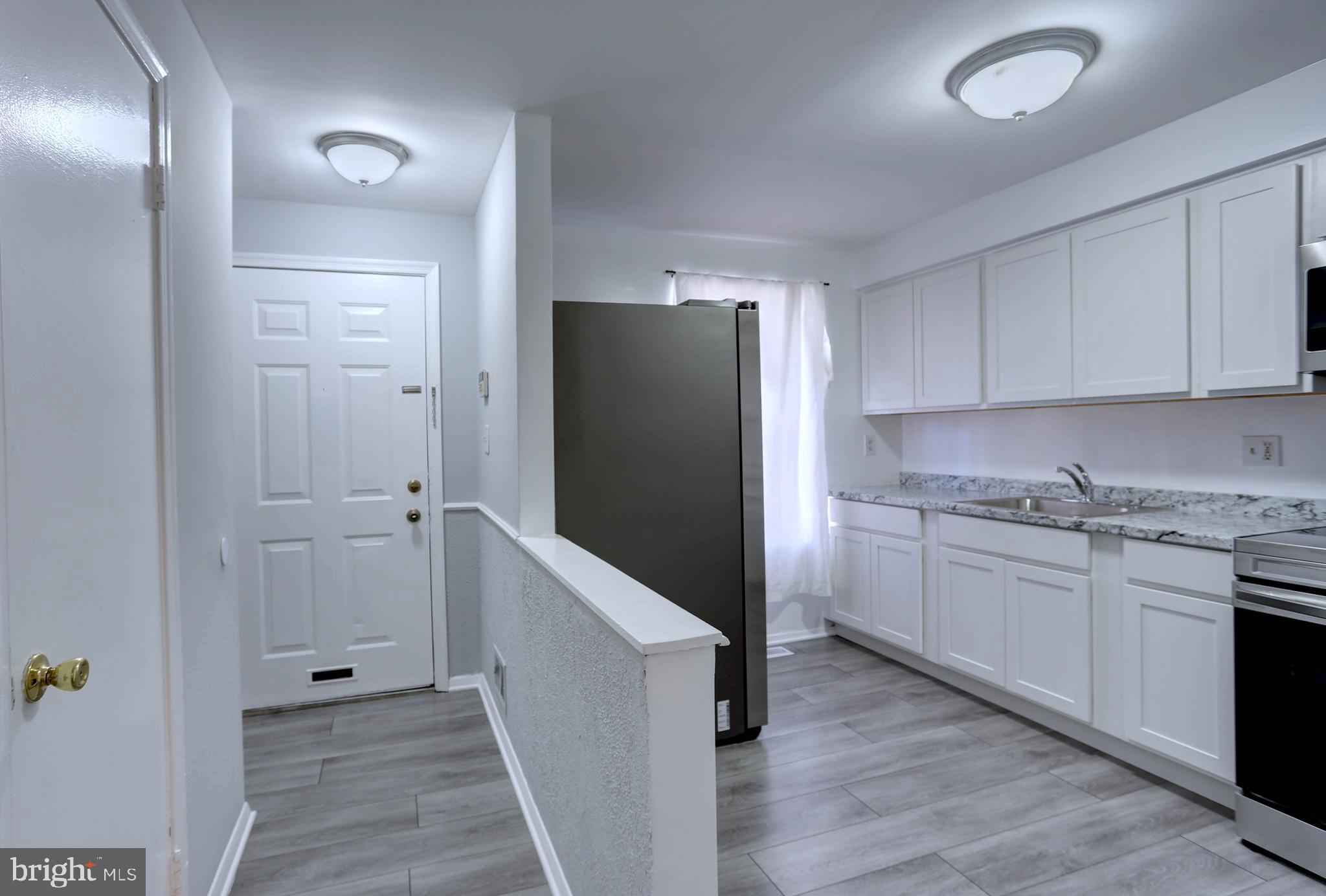 410 South Washington Street Baltimore, MD 21231 - Photo 3 of 29 a kitchen with cabinets and wooden floor