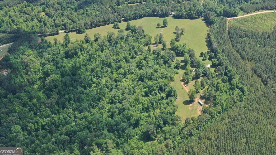 an aerial view of a house with a yard