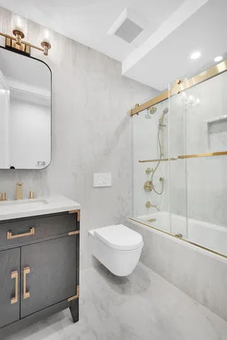 a bedroom with a large bed and a potted plant