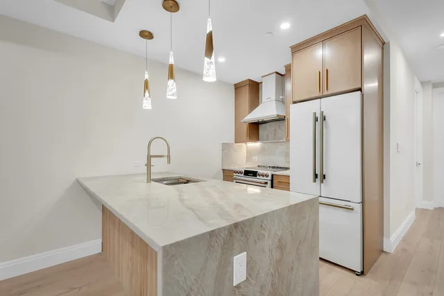 a view of dining room and kitchen with furniture wooden floor and a chandelier