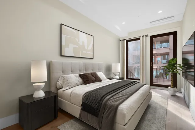 a view of a dining room with furniture a chandelier and wooden floor