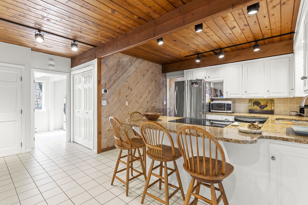 92 Middleton Road Boxford, MA 01921 - Photo 11 of 42 a kitchen with stainless steel appliances a refrigerator and wooden cabinets