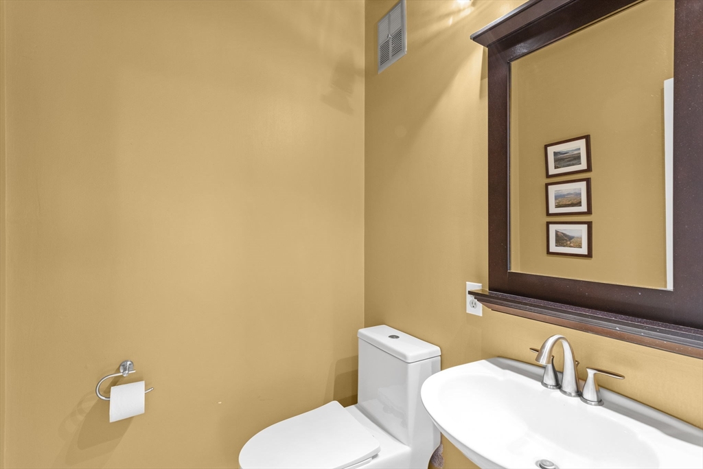 92 Middleton Road Boxford, MA 01921 - Photo 23 of 42 a bathroom with a toilet sink and mirror