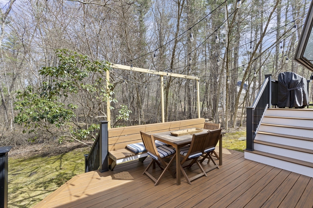 92 Middleton Road Boxford, MA 01921 - Photo 5 of 42 a view of a patio with table and chairs with wooden floor and fence