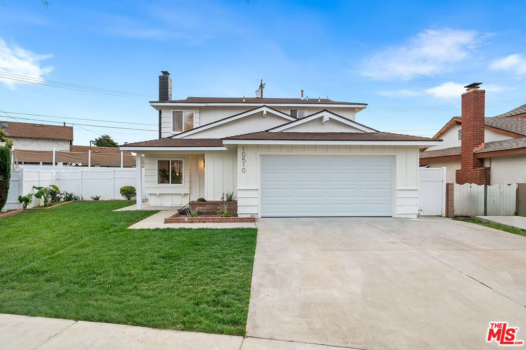 a front view of a house with swimming pool yard and patio