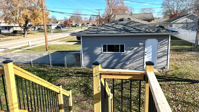 a view of a house with backyard and sitting area