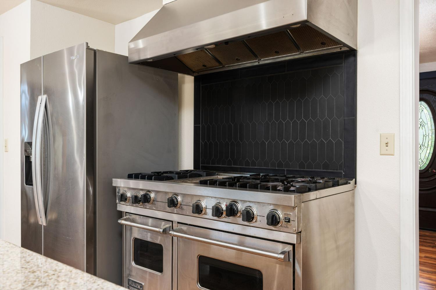 38303 Woodland Road Shaver Lake, CA 93664 - Photo 10 of 28 a kitchen with a stove and a refrigerator