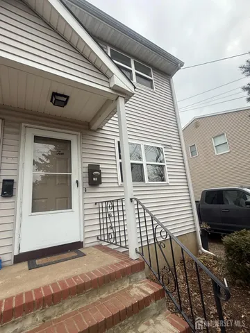 a view of a house with a door and wooden floor