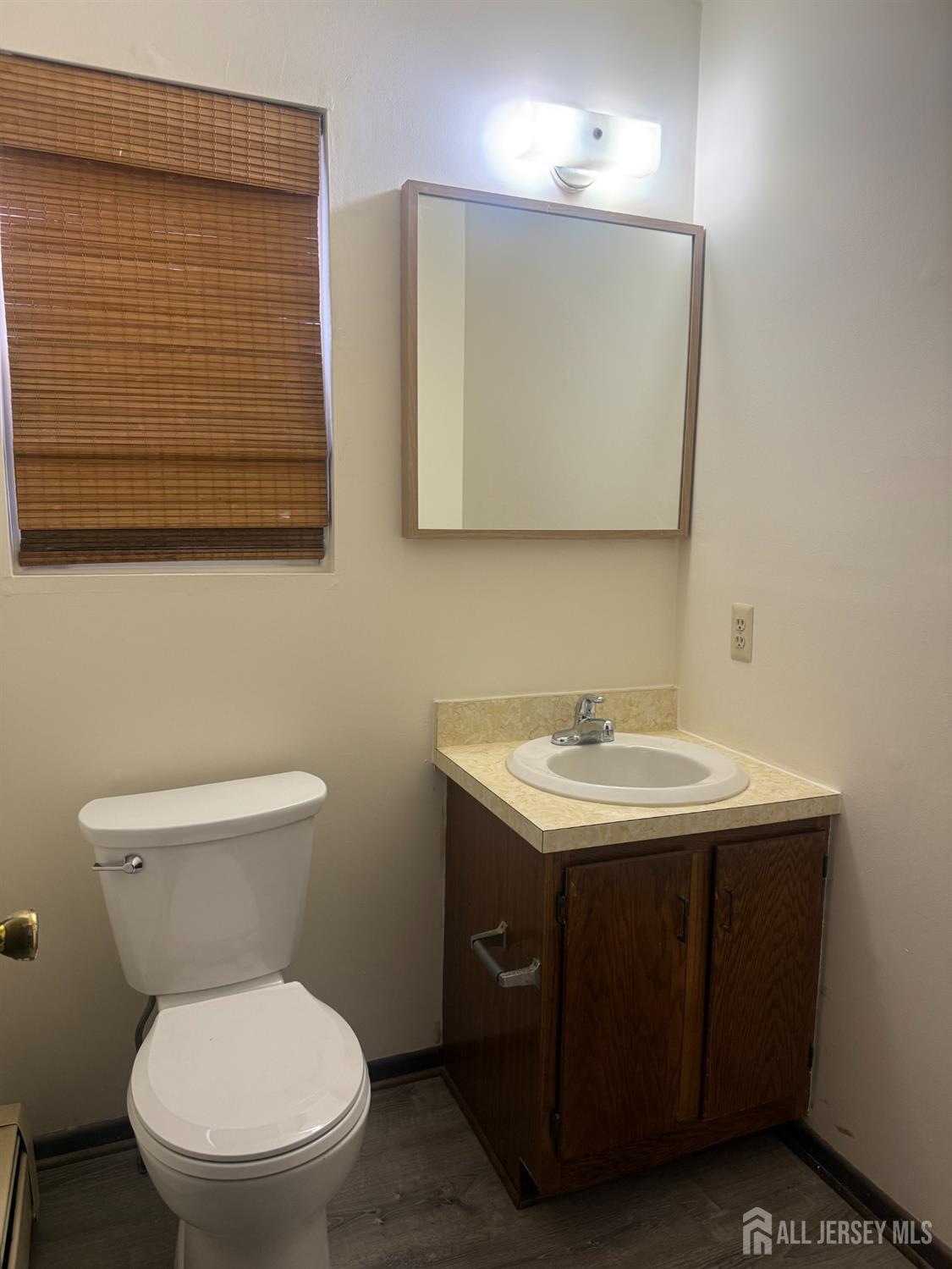 710-712 Drake Avenue, Unit 710 Middlesex, NJ 08846 - Photo 14 of 25 a bathroom with a toilet sink and mirror
