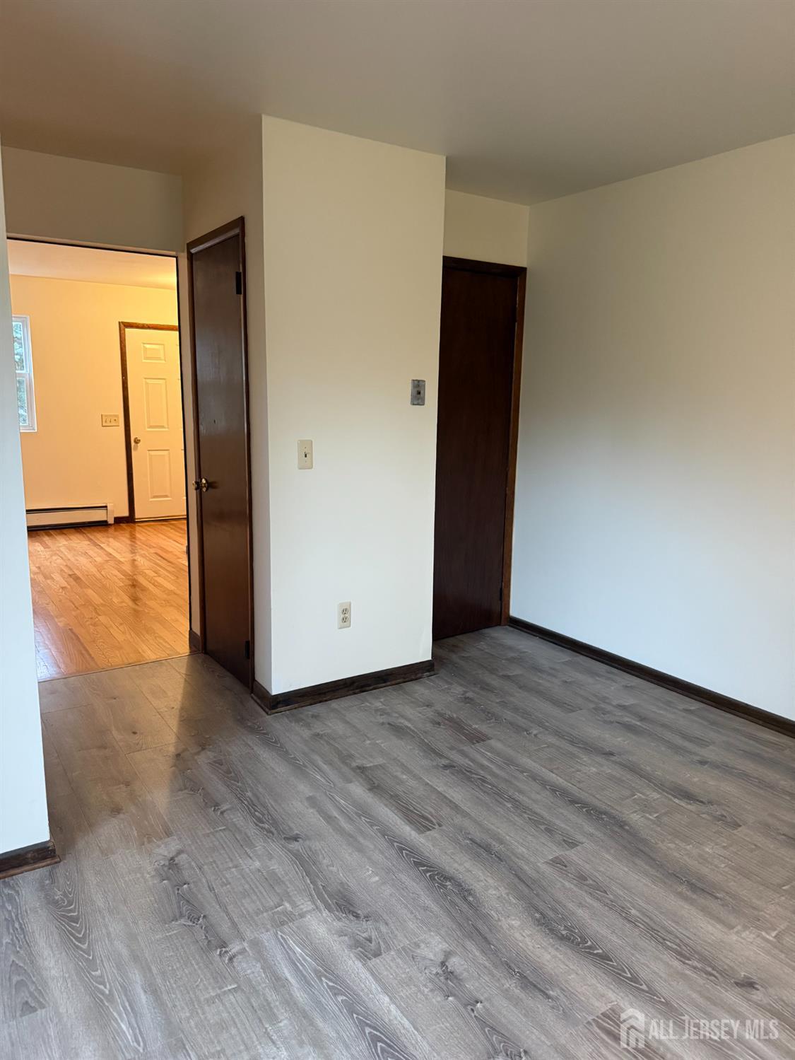 710-712 Drake Avenue, Unit 710 Middlesex, NJ 08846 - Photo 18 of 25 a view of an empty room with wooden floor and a window