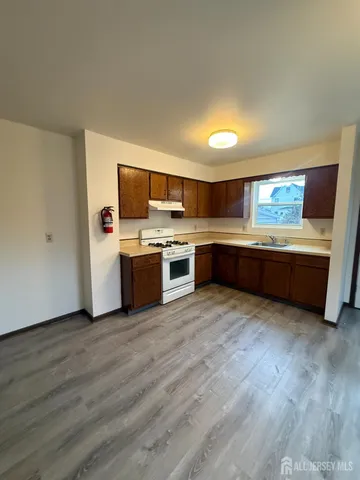 a kitchen with stainless steel appliances granite countertop a sink and a stove top oven