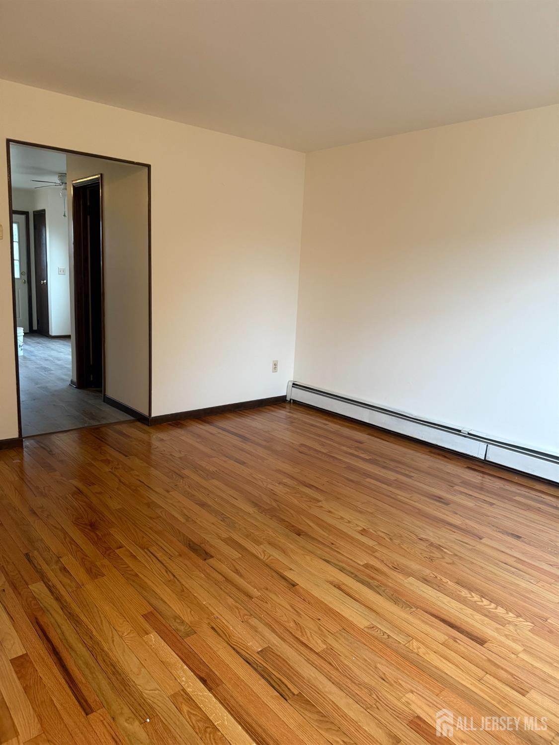 710-712 Drake Avenue, Unit 710 Middlesex, NJ 08846 - Photo 6 of 25 a view of an empty room and wooden floor
