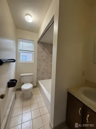 a bathroom with a toilet a sink and bathtub