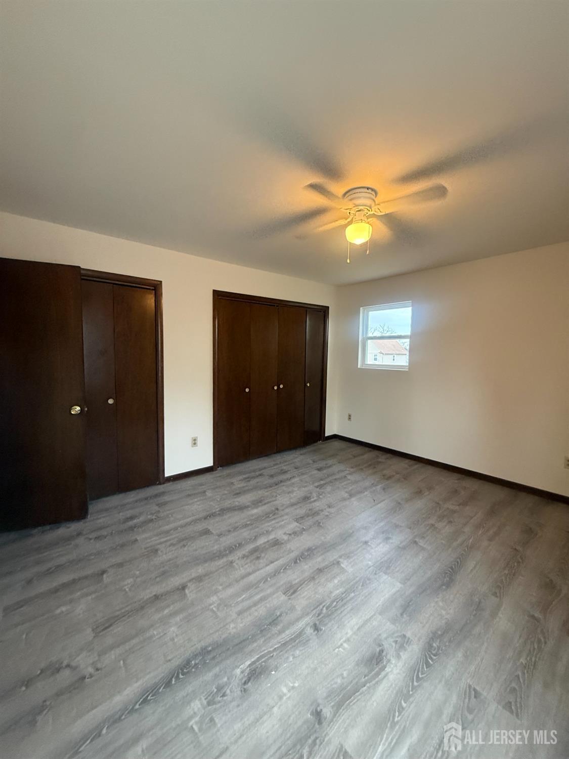 710-712 Drake Avenue, Unit 710 Middlesex, NJ 08846 - Photo 9 of 25 a view of an empty room and window and wooden floor