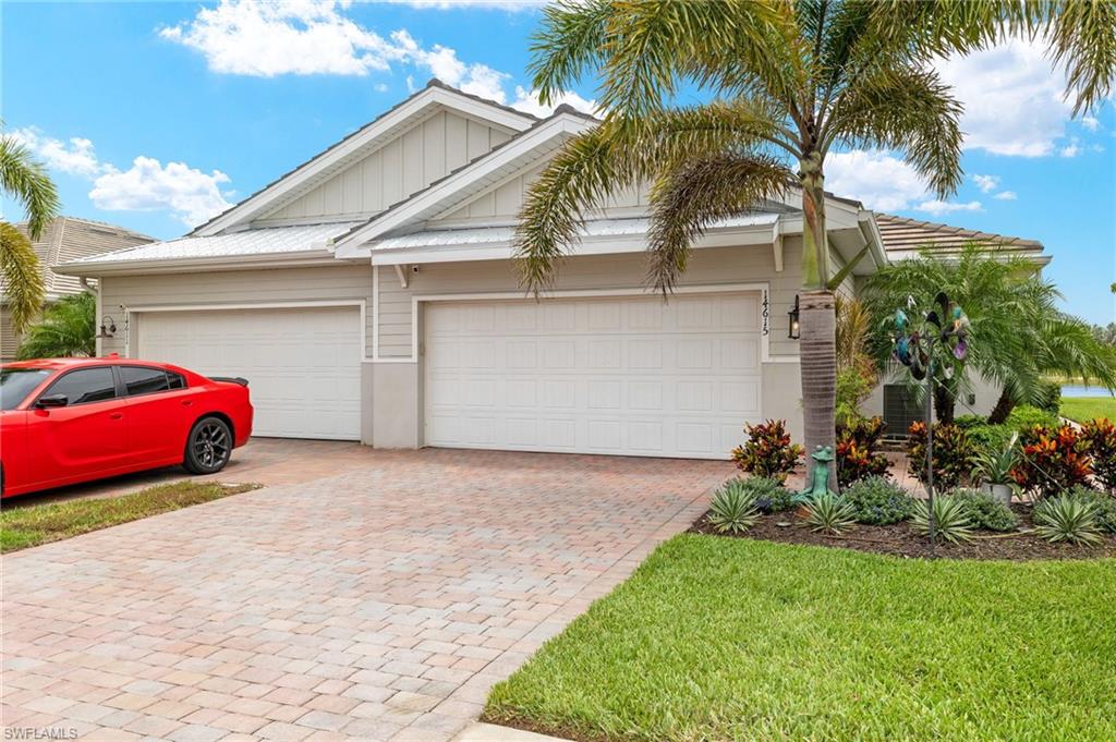 14615 Edgewater Circle Naples, FL 34114 - Photo 1 of 42 a front view of a house with a yard and a garage