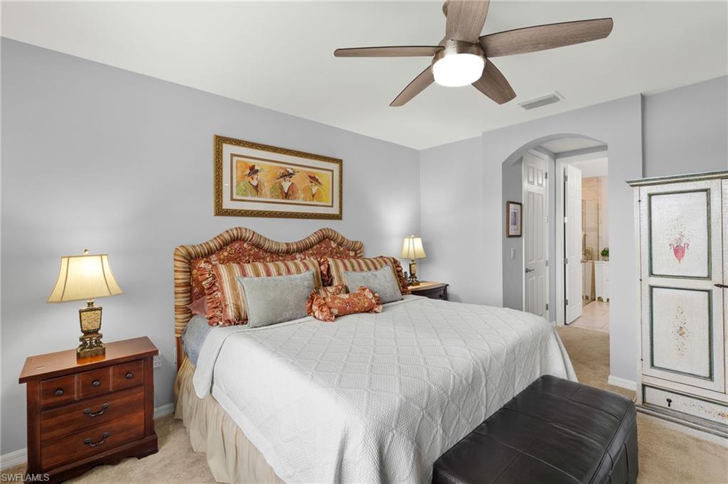 14615 Edgewater Circle Naples, FL 34114 - Photo 14 of 42 a bedroom with bed and wooden floor