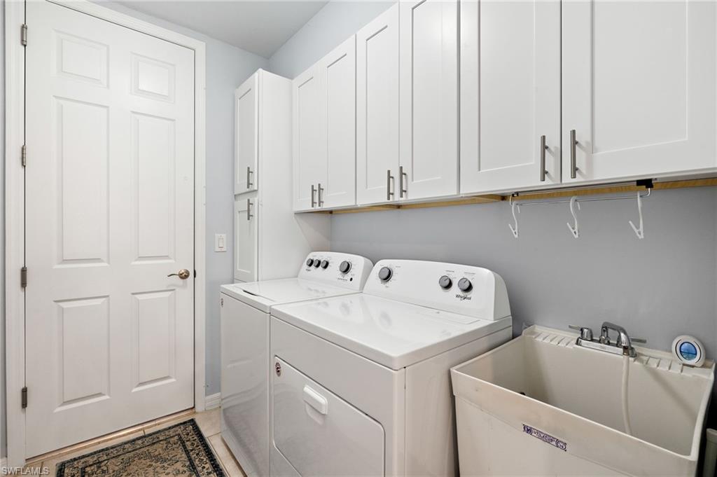 14615 Edgewater Circle Naples, FL 34114 - Photo 20 of 42 a utility room with dryer and washer