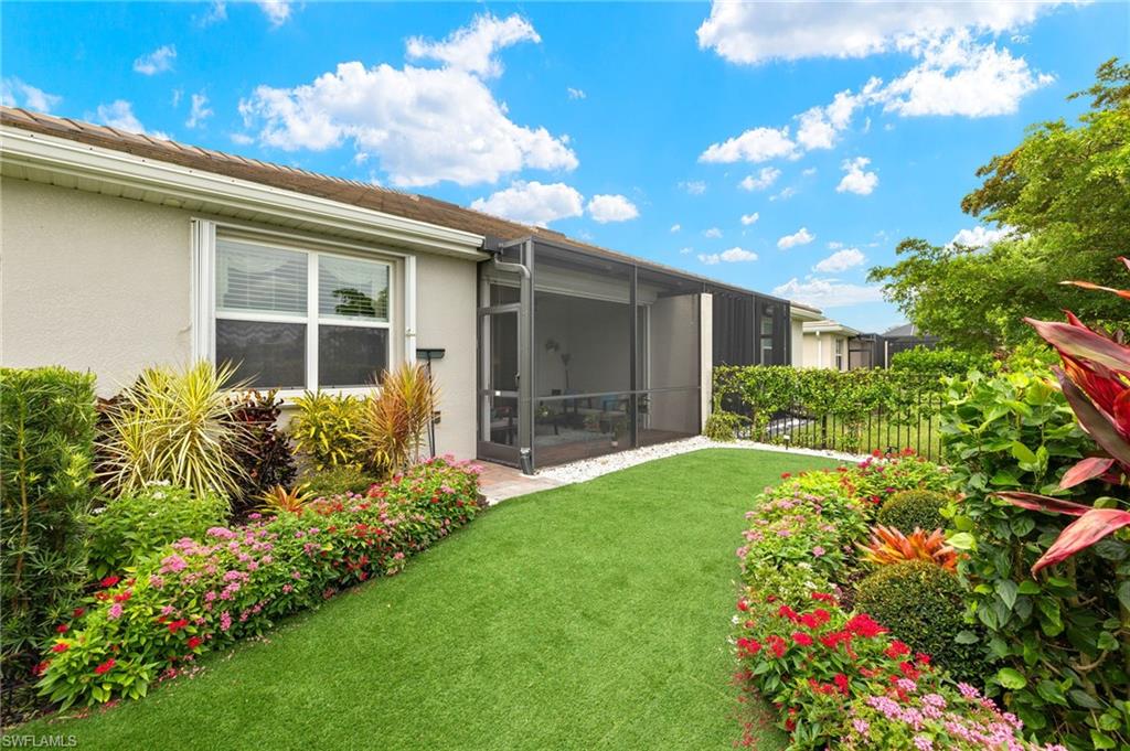 14615 Edgewater Circle Naples, FL 34114 - Photo 22 of 42 a front view of a house with garden