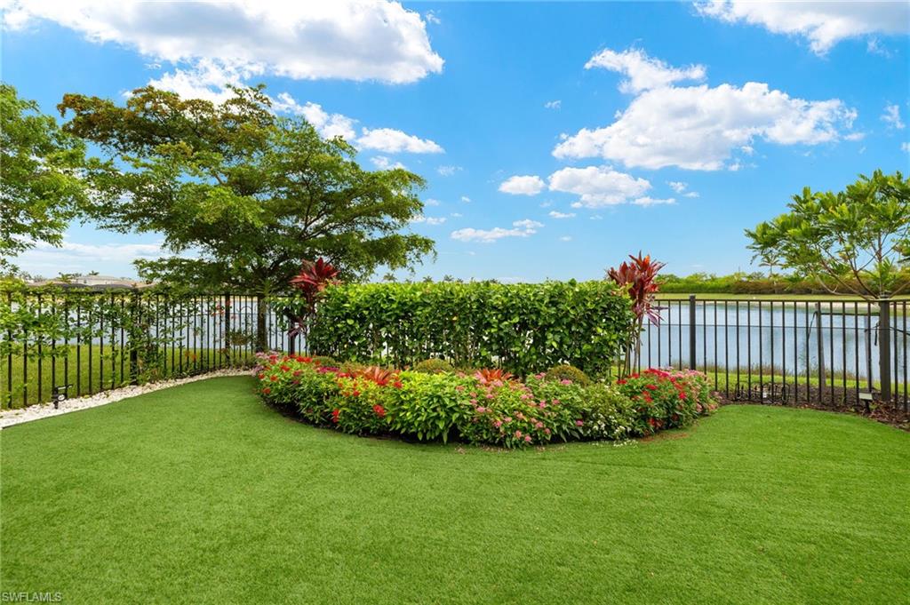 14615 Edgewater Circle Naples, FL 34114 - Photo 24 of 42 a view of a garden with a tree in the background