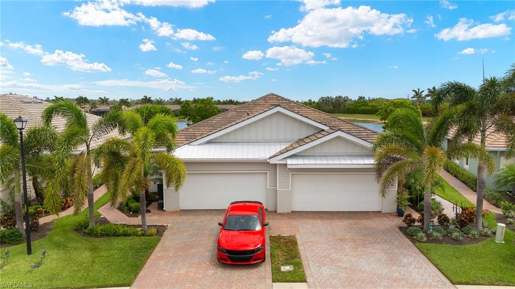 14615 Edgewater Circle Naples, FL 34114 - Photo 26 of 42 a view of a house with a yard and potted plants