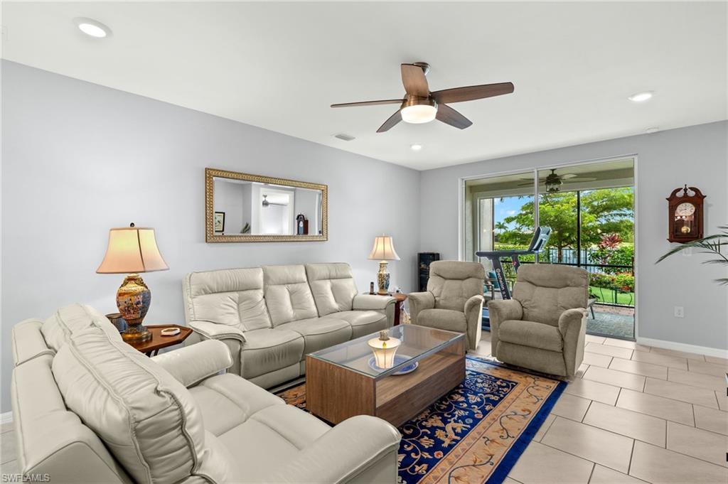 14615 Edgewater Circle Naples, FL 34114 - Photo 3 of 42 a living room with furniture and a large window