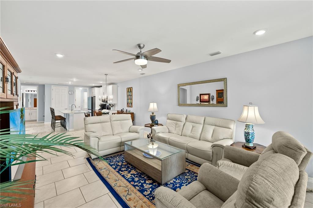 14615 Edgewater Circle Naples, FL 34114 - Photo 4 of 42 a living room with furniture and a rug
