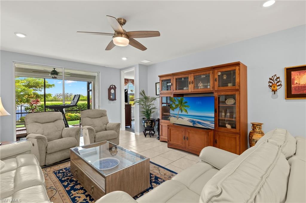 14615 Edgewater Circle Naples, FL 34114 - Photo 5 of 42 a living room with furniture and a large window