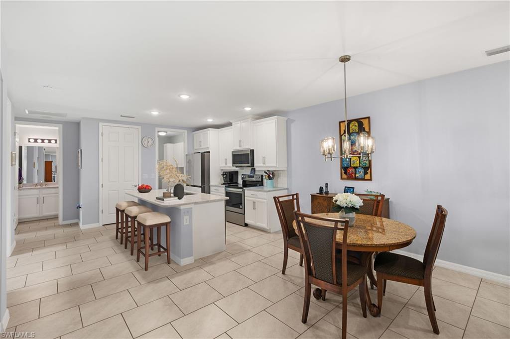 14615 Edgewater Circle Naples, FL 34114 - Photo 6 of 42 a view of a dining room with furniture