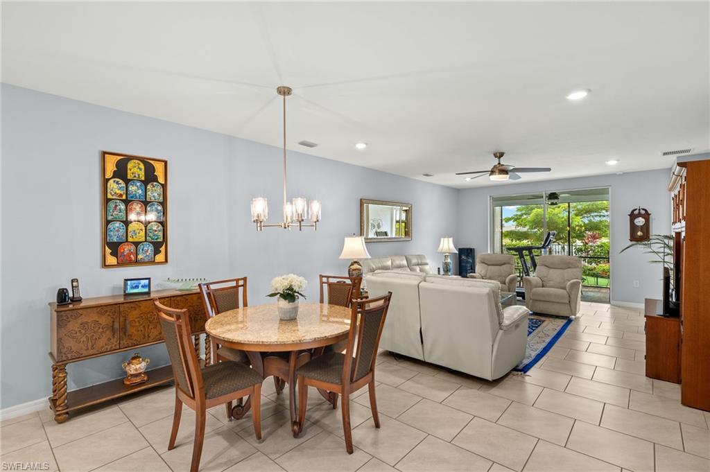 14615 Edgewater Circle Naples, FL 34114 - Photo 7 of 42 a view of a dining room with furniture and a chandelier
