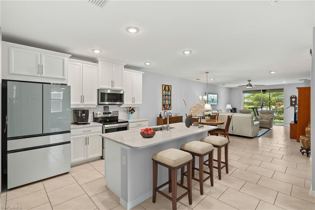 14615 Edgewater Circle Naples, FL 34114 - Photo 9 of 42 a kitchen with stainless steel appliances lots of counter top space