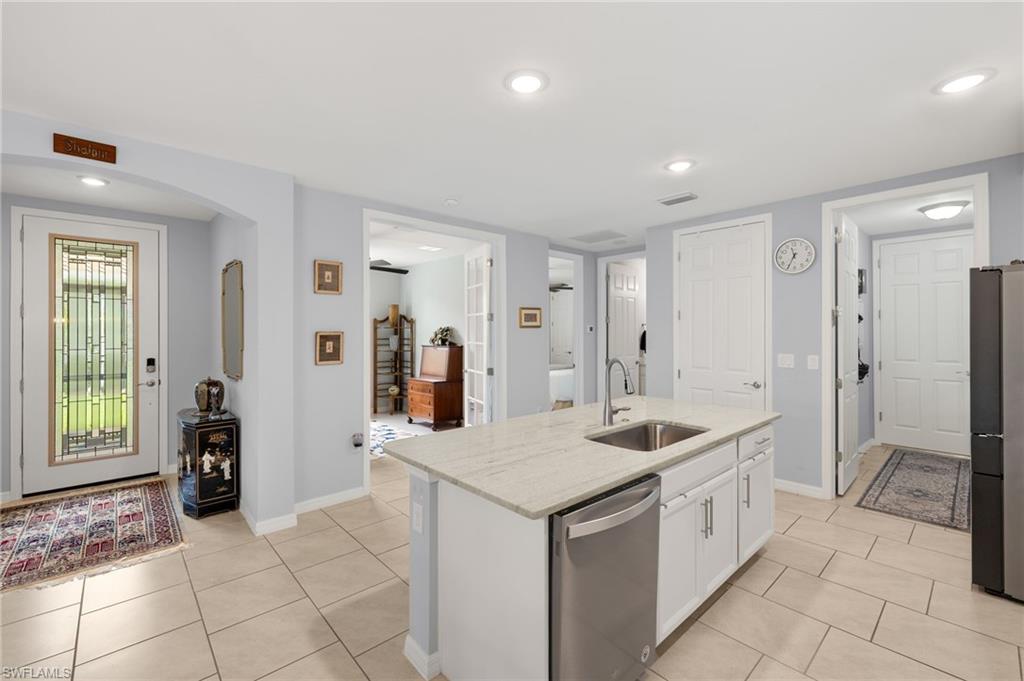 14615 Edgewater Circle Naples, FL 34114 - Photo 10 of 42 a kitchen with sink and refrigerator