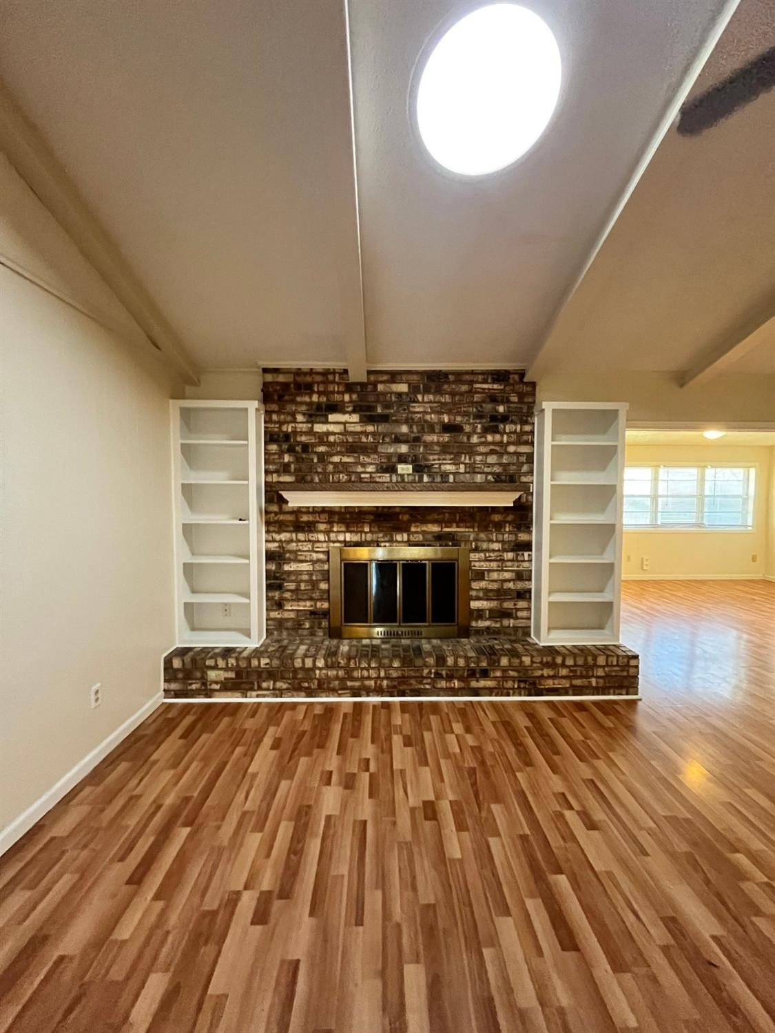 6305 Raleigh Avenue Lubbock, TX 79414 - Photo 14 of 19 a view of an empty room with wooden floor and a window