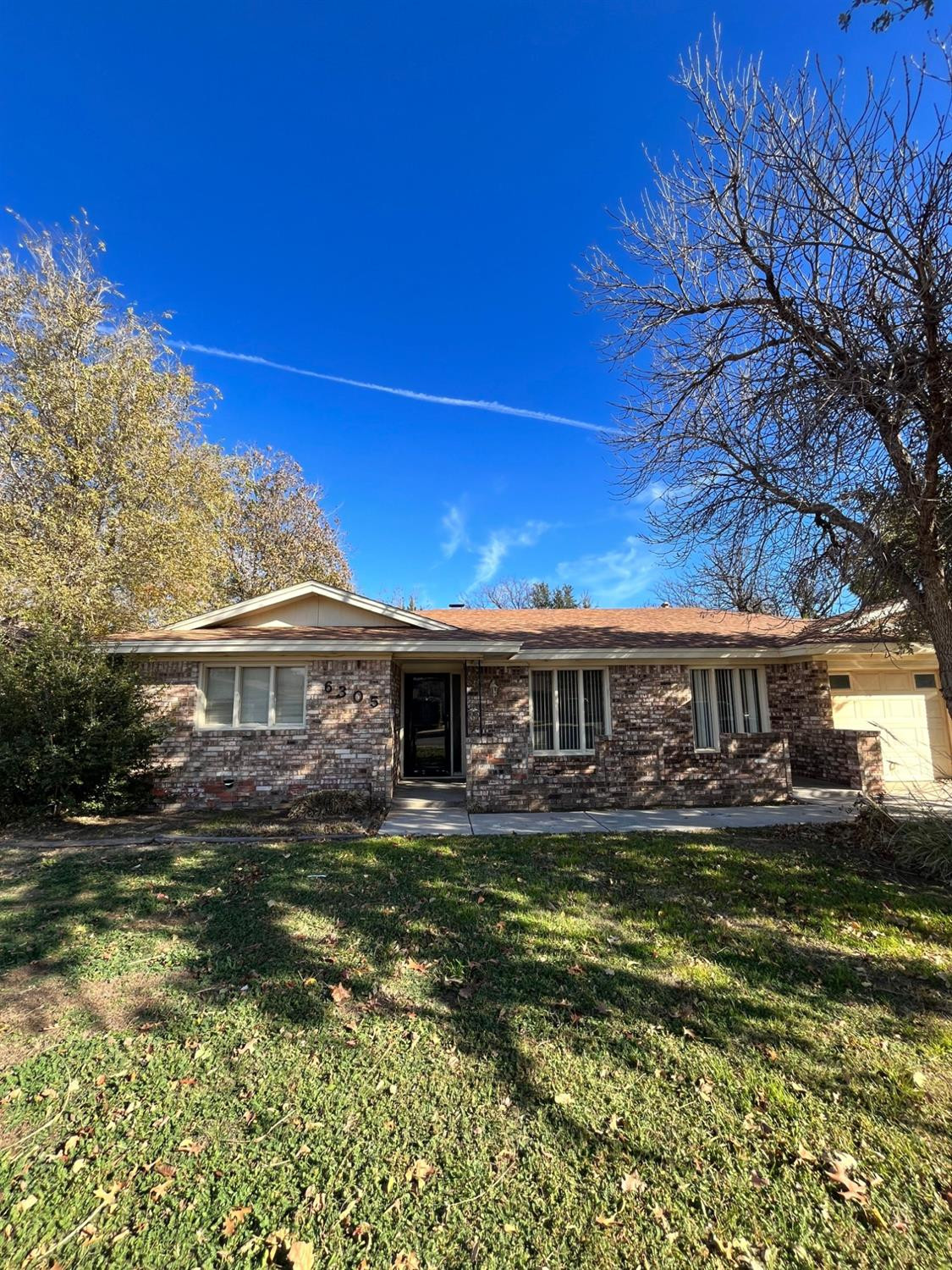 6305 Raleigh Avenue Lubbock, TX 79414 - Photo 2 of 19 front view of a house with a yard