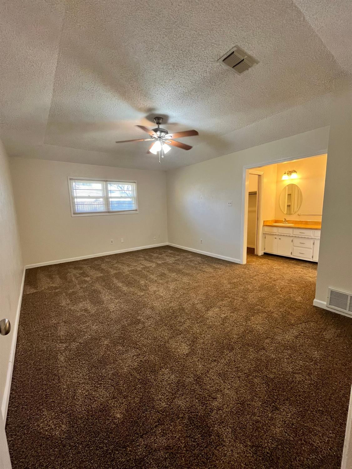 6305 Raleigh Avenue Lubbock, TX 79414 - Photo 6 of 19 a view of an empty room with a window