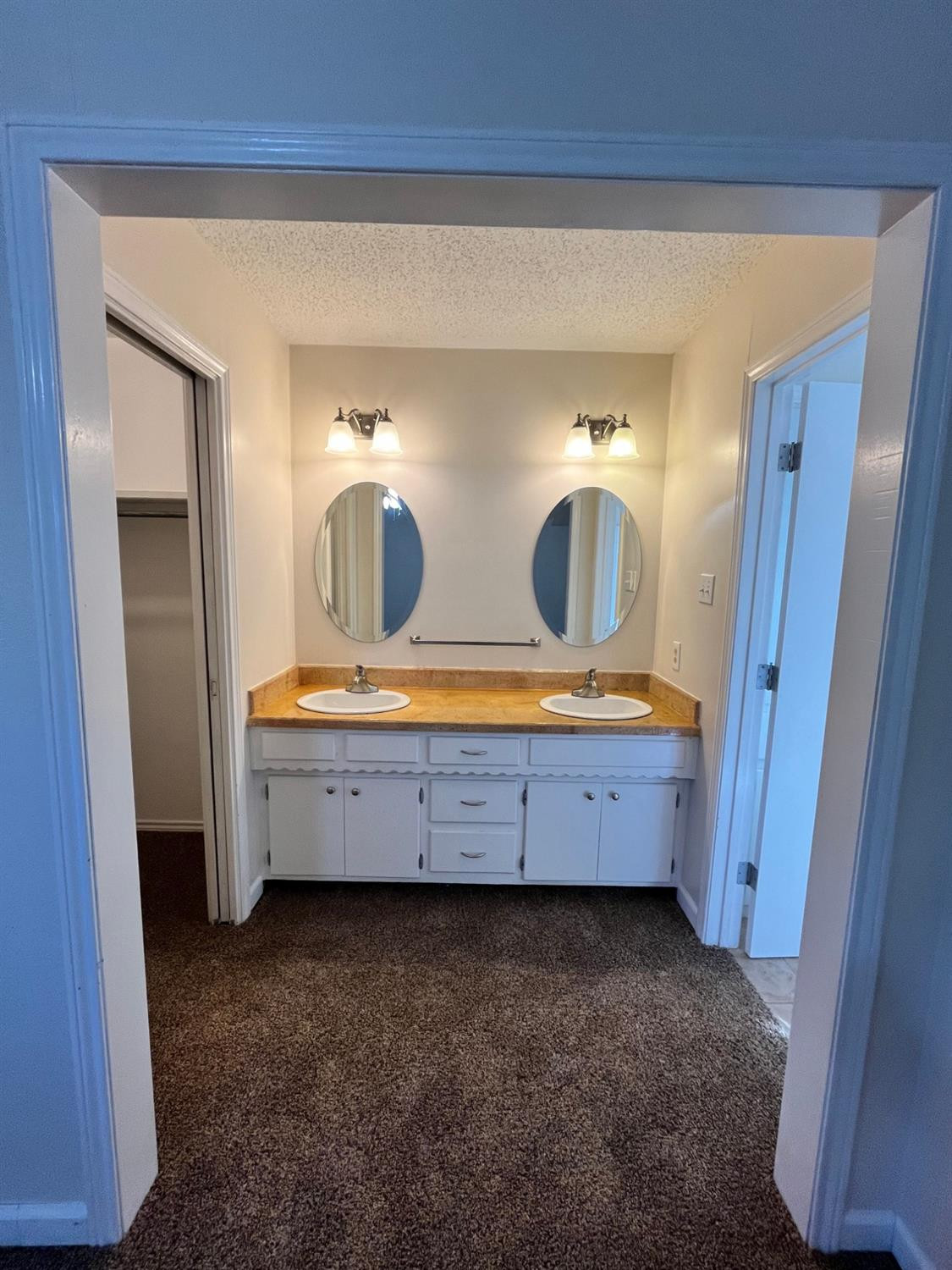 6305 Raleigh Avenue Lubbock, TX 79414 - Photo 8 of 19 a bathroom with double vanity and a mirror