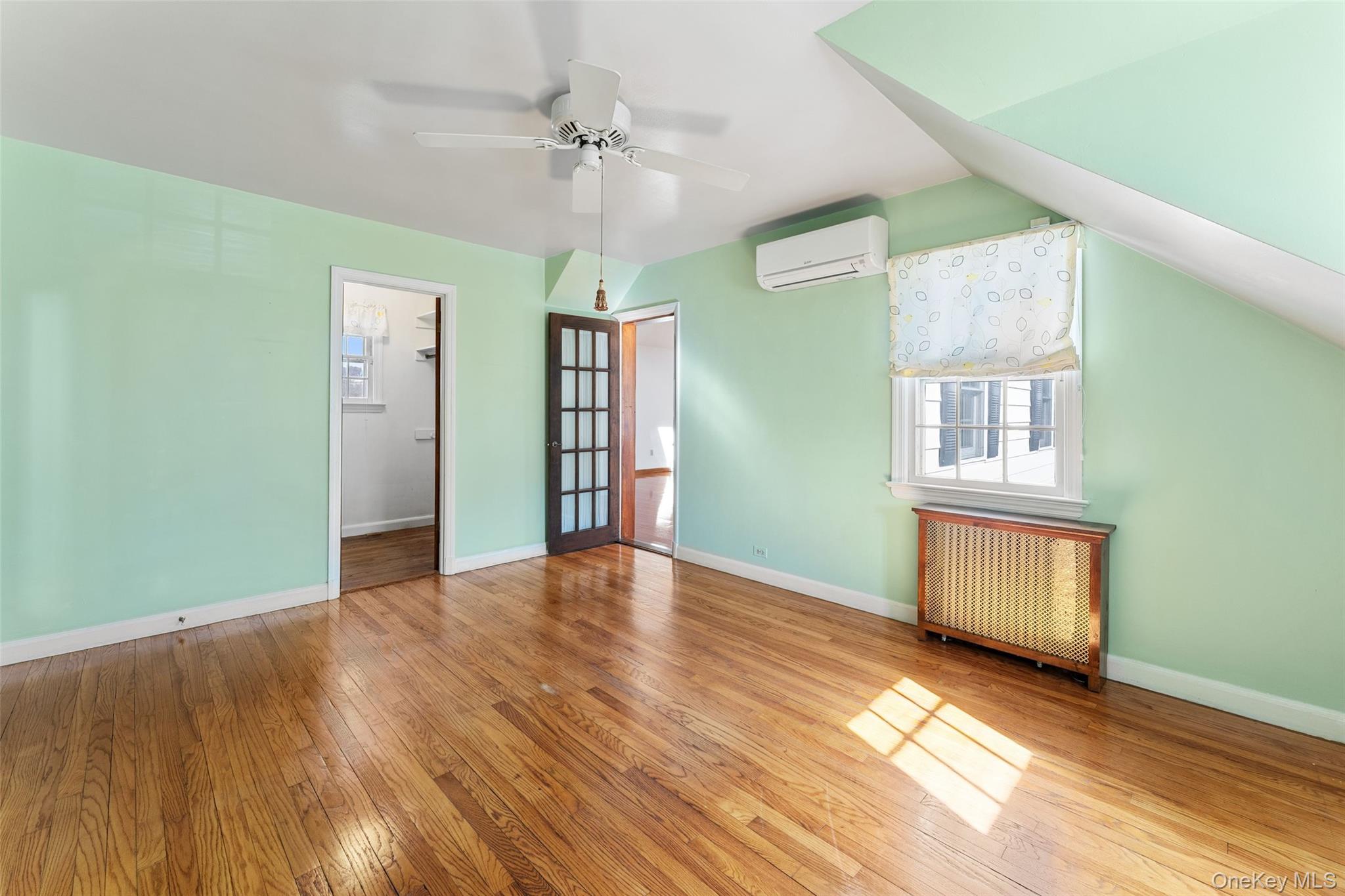 1 Hoover Road Yonkers, NY 10710 - Photo 15 of 50 an empty room with wooden floor chandelier fan and windows