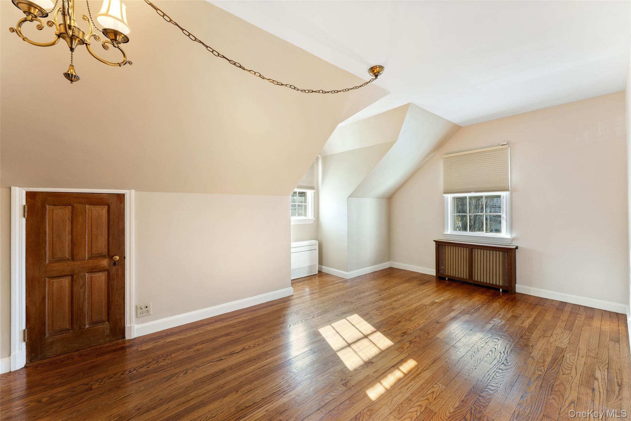 1 Hoover Road Yonkers, NY 10710 - Photo 18 of 50 a view of an empty room with wooden floor and a window