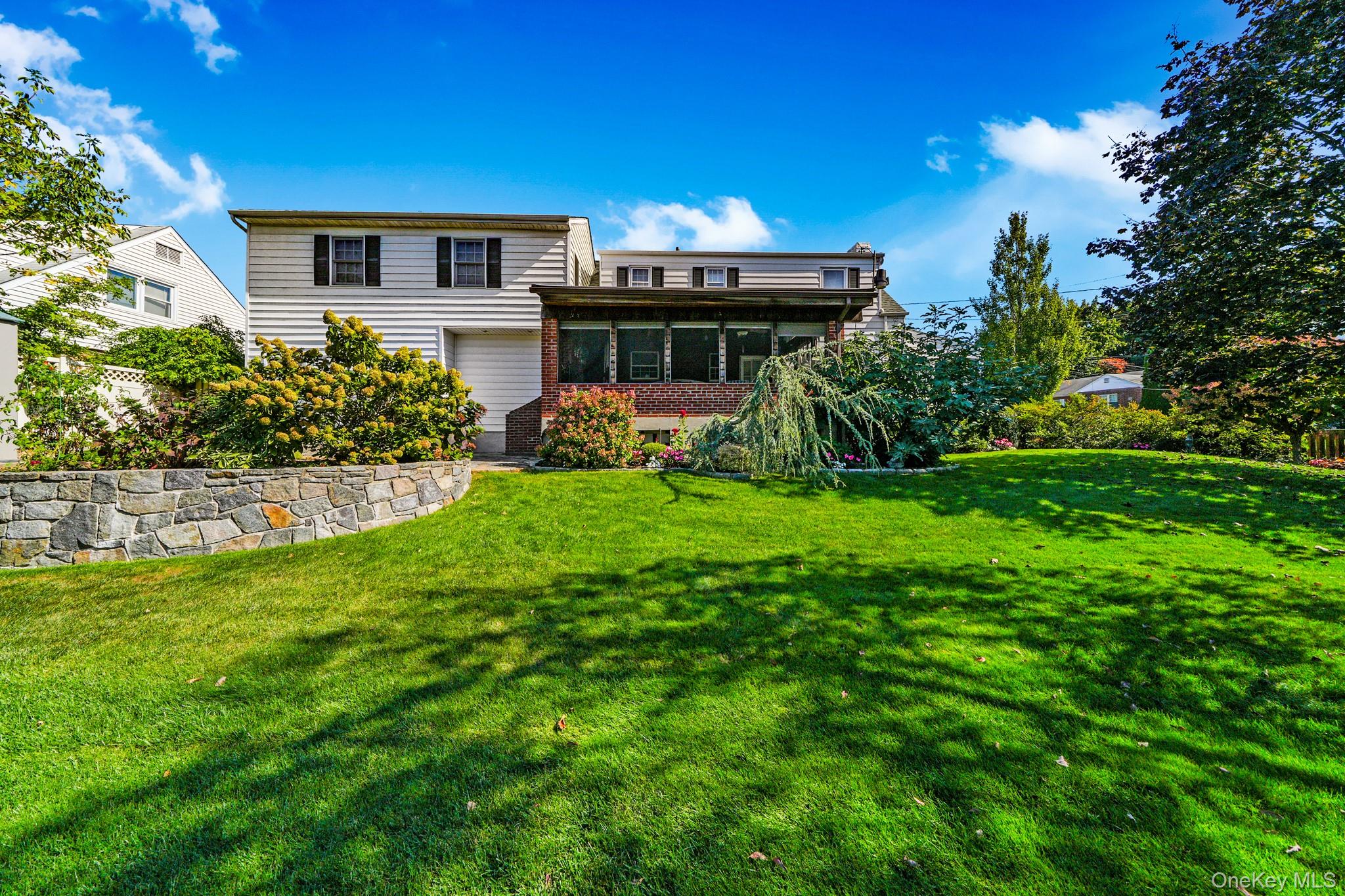 1 Hoover Road Yonkers, NY 10710 - Photo 21 of 50 a front view of a house with a yard