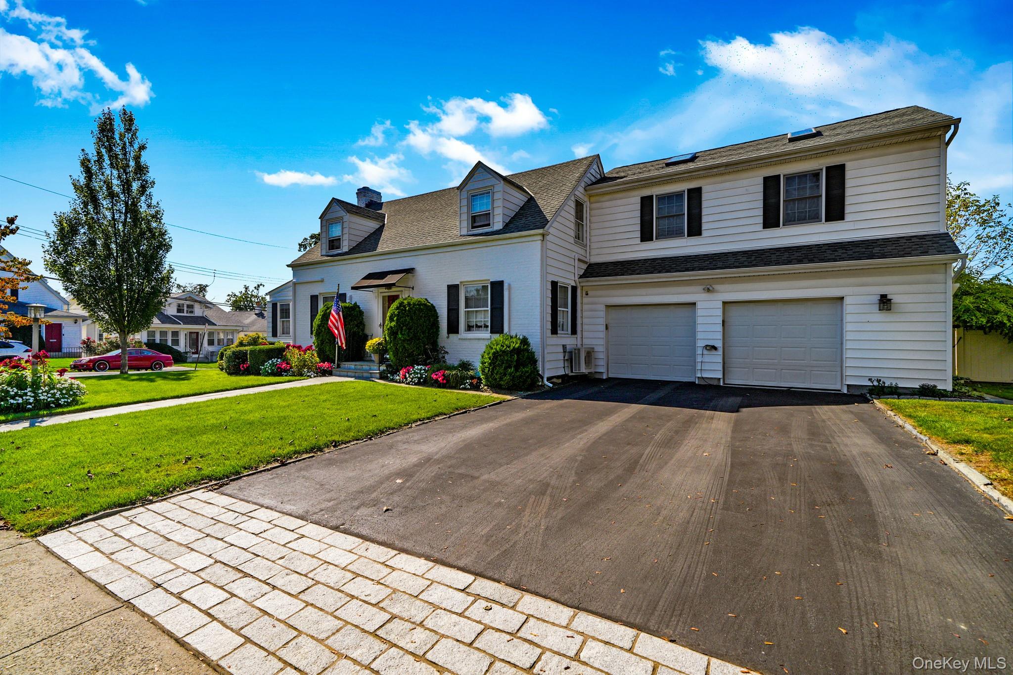 1 Hoover Road Yonkers, NY 10710 - Photo 34 of 50 a front view of a house with a yard and garage