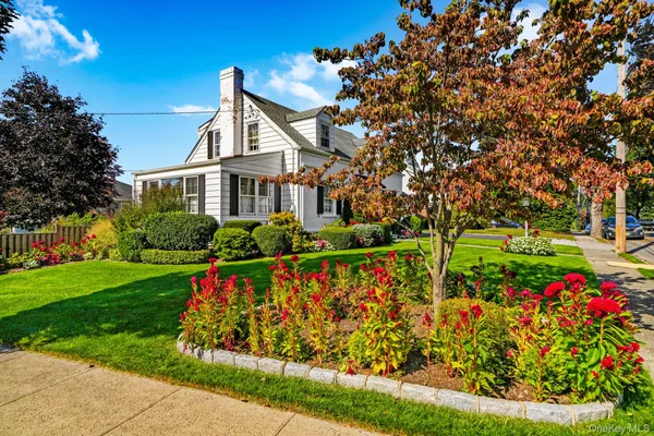 front view of a house with a big yard and potted plants