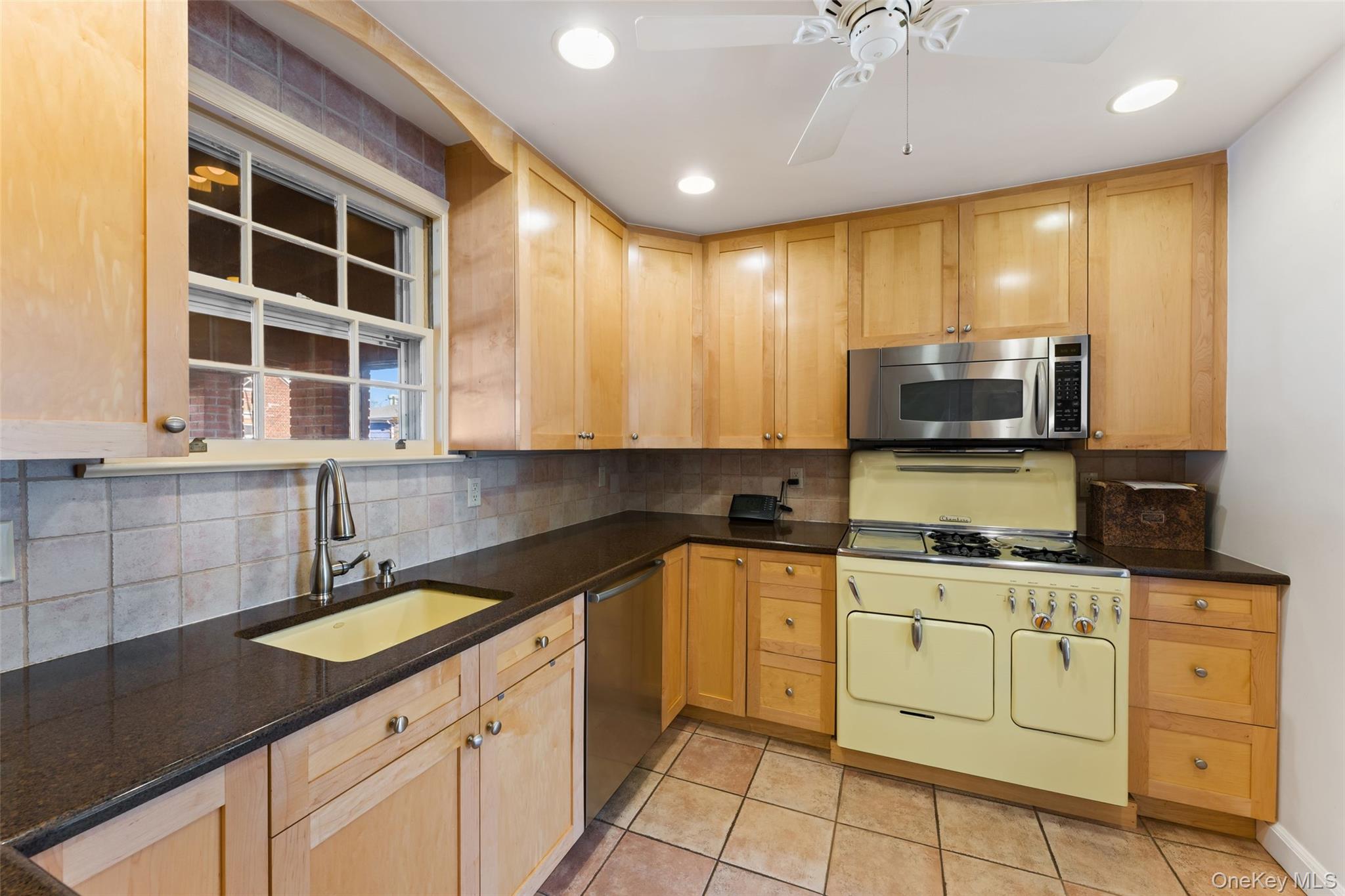 1 Hoover Road Yonkers, NY 10710 - Photo 9 of 50 a kitchen with a sink window and cabinets