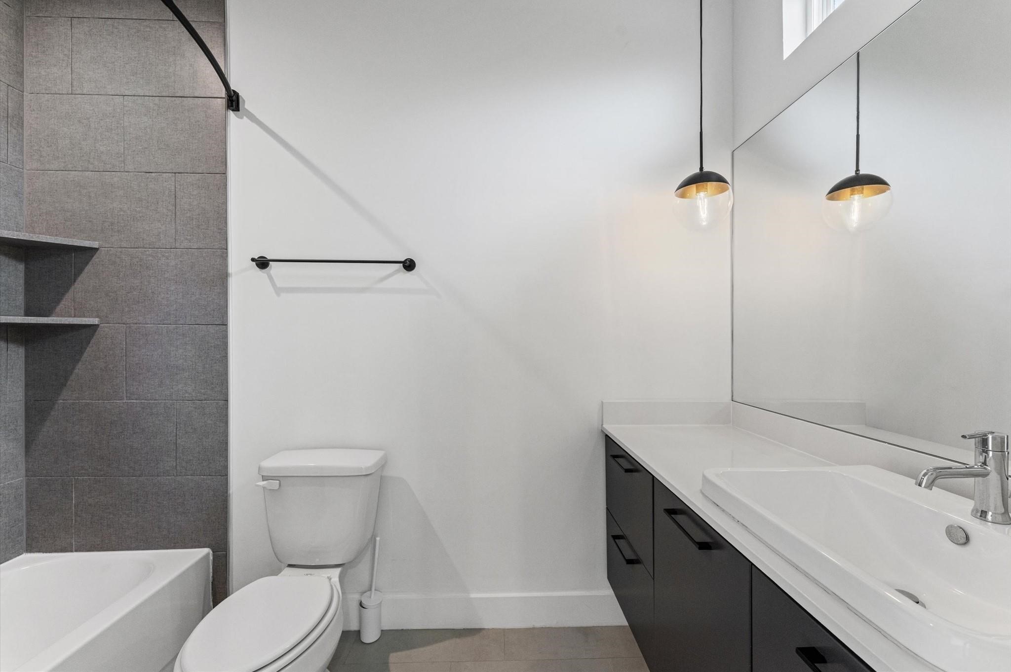 1404 Bailey Street Houston, TX 77019 - Photo 23 of 23 a bathroom with a sink a toilet and shower