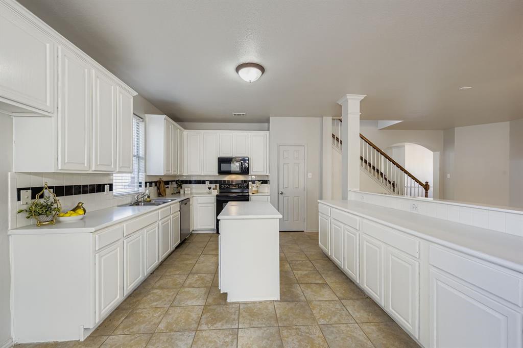 4201 Broken Bend Boulevard Fort Worth, TX 76244 - Photo 12 of 34 a kitchen with cabinets and white appliances