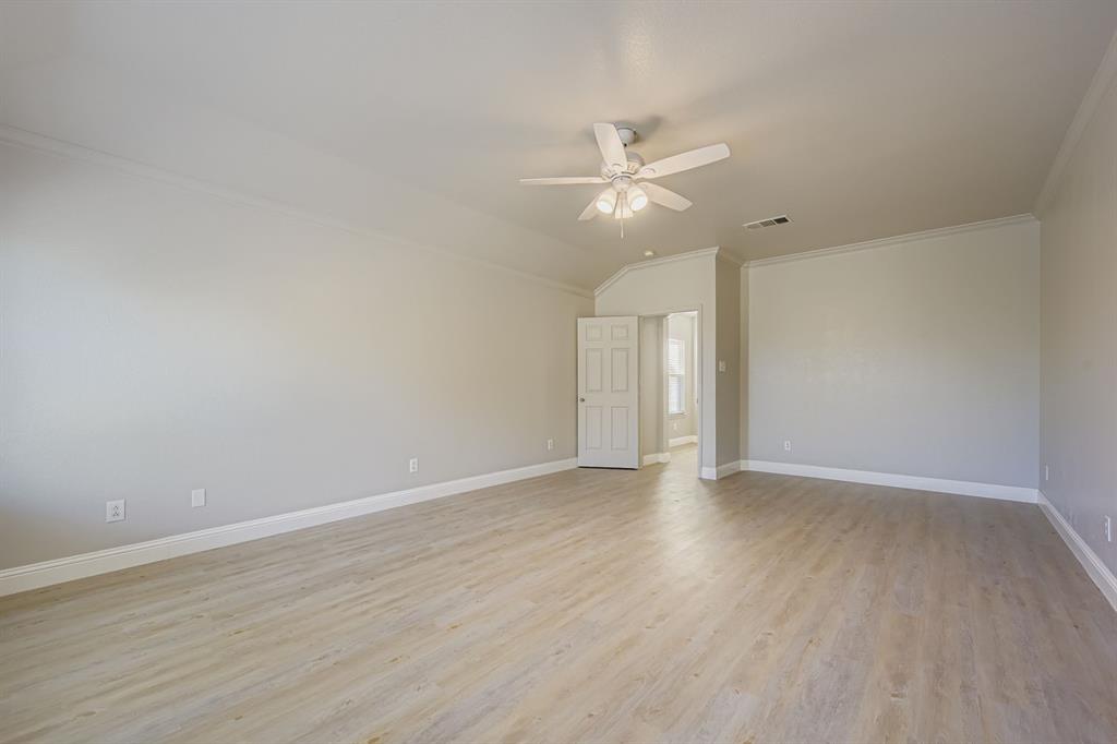 4201 Broken Bend Boulevard Fort Worth, TX 76244 - Photo 16 of 34 an empty room with wooden floor fan and windows
