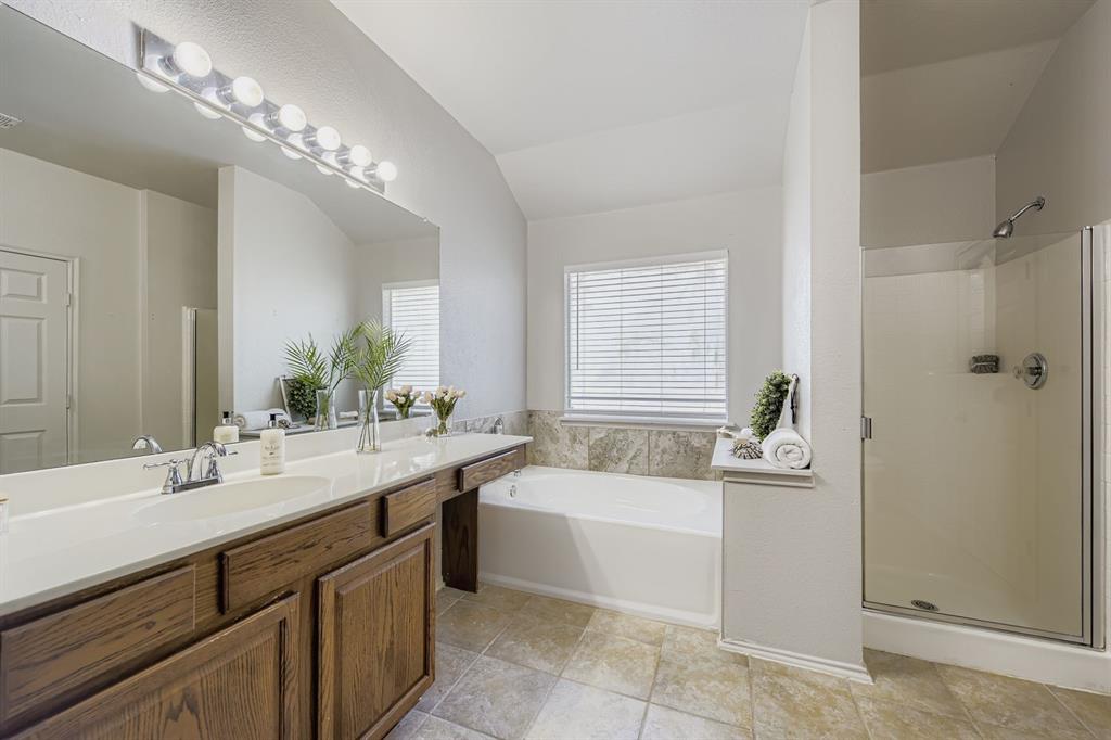 4201 Broken Bend Boulevard Fort Worth, TX 76244 - Photo 17 of 34 a bathroom with a tub a sink double vanity and a mirror